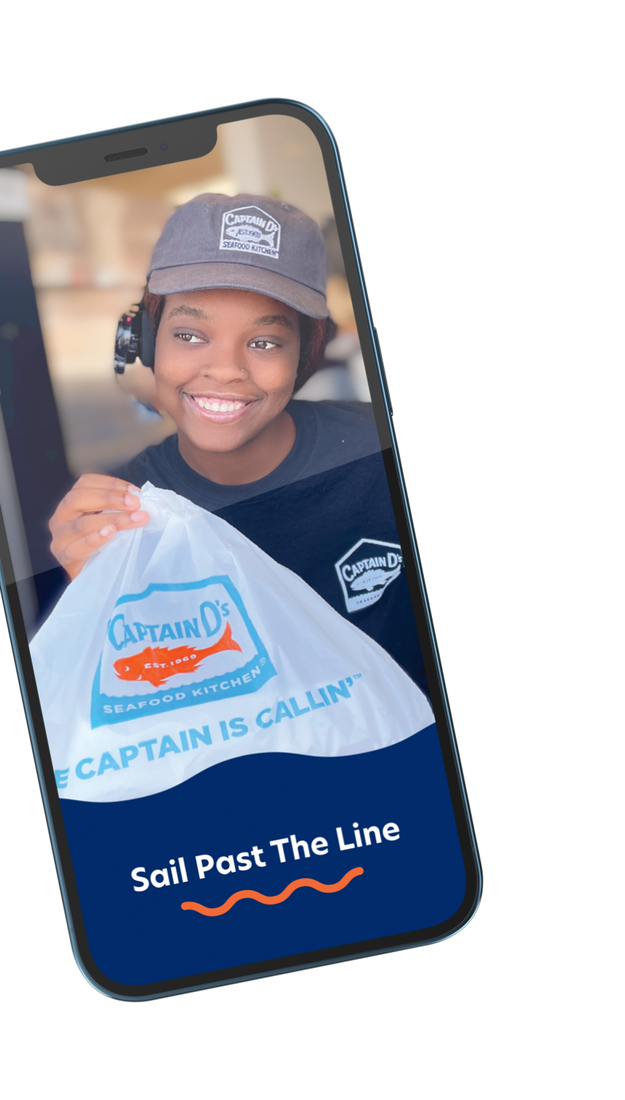 Phone showing the Captain D's app with an image of a drive thru worker handing a bag of food to a customer (offscreen).